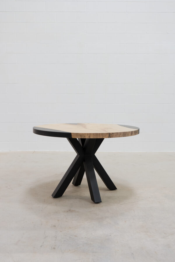 hand-crafted wooden dining room table with black metal legs.