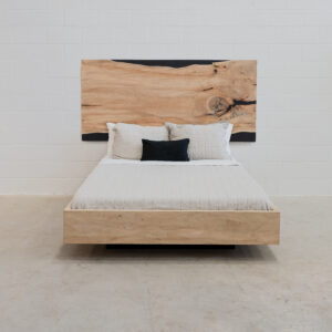 wooden bedframe that appears to be hovering, with a beautiful wood headboard.