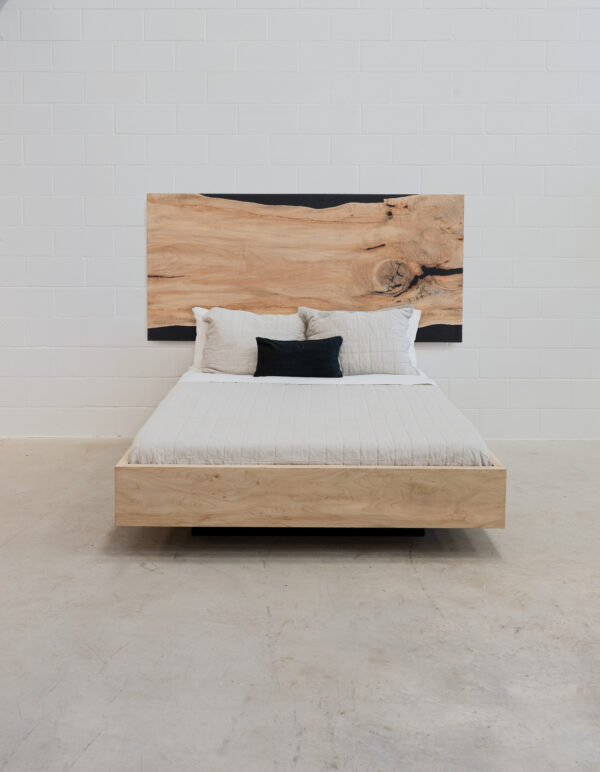 wooden bedframe that appears to be hovering, with a beautiful wood headboard.